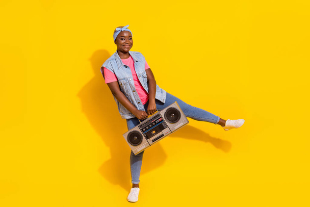Full length portrait of excited overjoyed girl hold vintage boom box isolated on yellow color background. - Foto, Bild