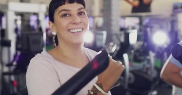 Portrait real, casual and normal people exercising on a treadmill at indoor fitness center. Happy, smiling sporty woman and man feeling excited while exercising and doing cardio warmup or training. - Filmati, video
