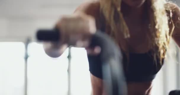 Strong, tired and sporty woman cycling at the gym while sweating on an exercise bike. Dedicated, sporty and athletic people doing a cardio workout to build stamina and endurance on at a health club. - Filmati, video