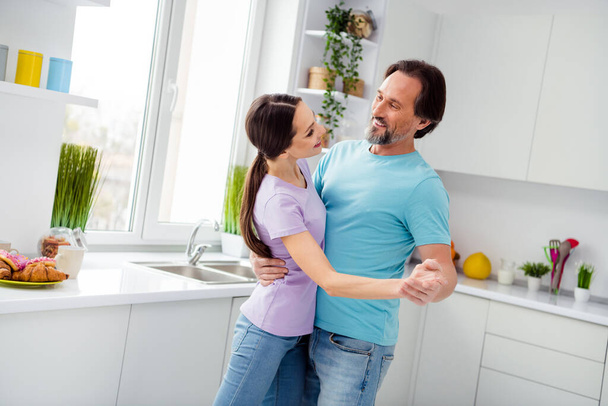 Photo of cheerful positive partners hug embrace dance kitchen room house indoors. - Valokuva, kuva