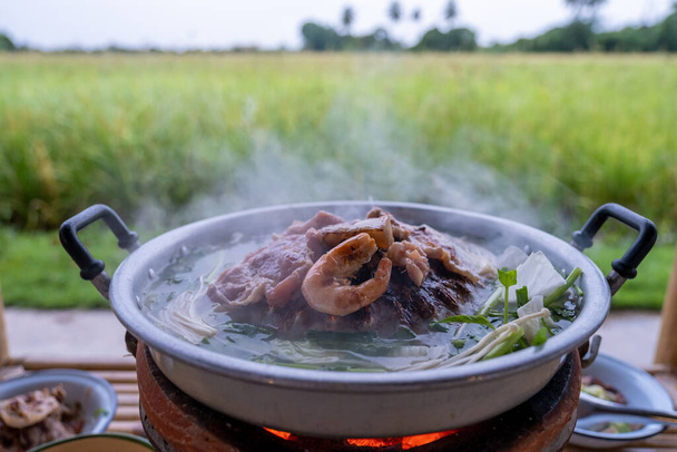 Korean bbq on vacation at a homestay in Thailand, eco farm with green rice paddy field during monsoon season in Thailand, Thai bbq - Fotoğraf, Görsel