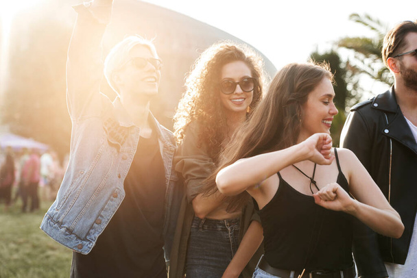 Group of young caucasian friends dancing and having fun at music festival - Photo, image