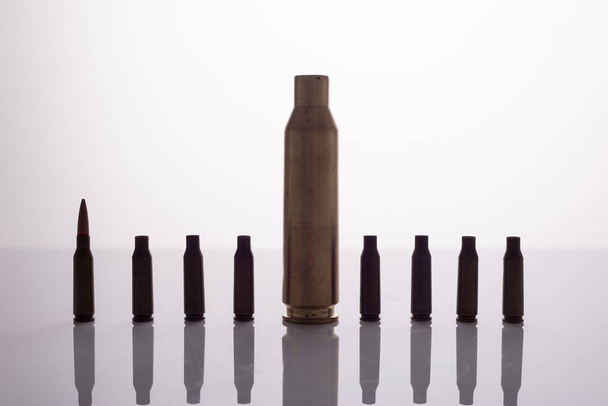 used spent shells of cartridges from a machine gun and a machine gun on a white background. - Foto, immagini
