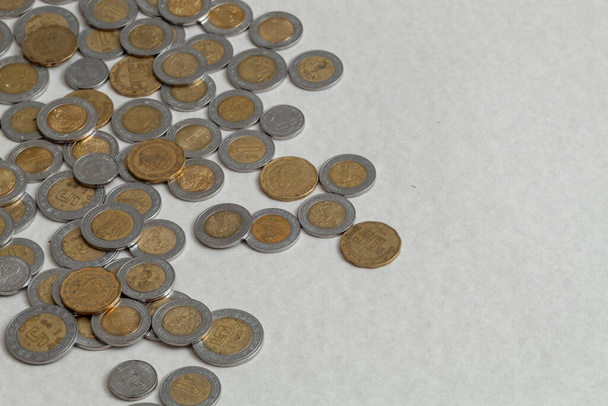 mexican peso coins scattered on the table with copy space. - Foto, Imagen