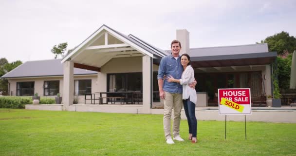 Homeowner couple standing outside of their new house, property or real estate after moving and relocating. Man and woman buying their first home, feeling happy and proud of their financial investment. - Filmagem, Vídeo