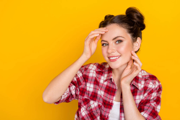 Photo of positive gorgeous lady hands touch face toothy smile look camera isolated on yellow color background. - 写真・画像