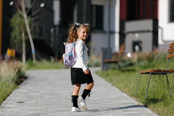 a little girl goes to school through the park along the path. distance education concept.  - Φωτογραφία, εικόνα