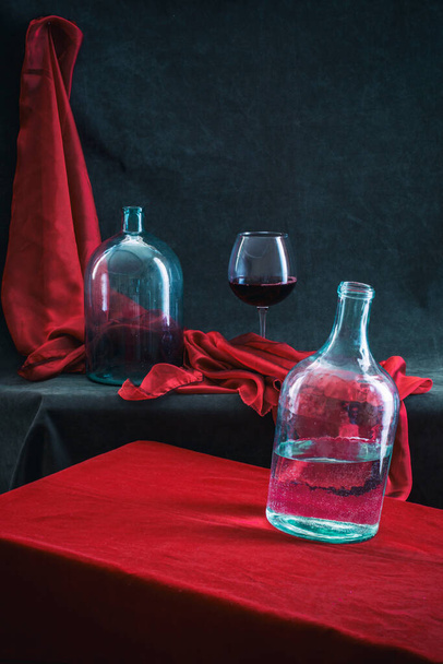 Still life with glass jars and a glass of wine - Foto, imagen