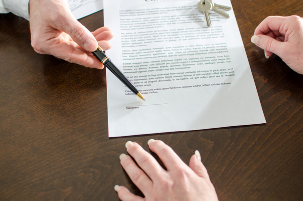Realtor showing the signature place of a contract - 写真・画像