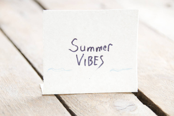 The inscription on a piece of paper summer vibe, vintage background - Фото, изображение