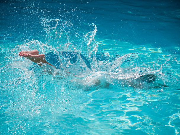 woman widing  on a blue water pool - Фото, зображення