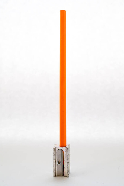 orange pencil with sharpener on white background - Foto, Bild