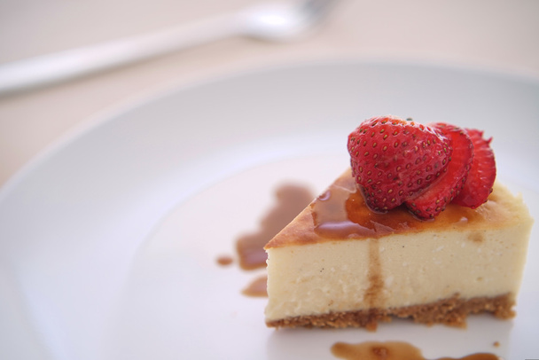 Small slice of cheesecake on a big plate - Foto, imagen