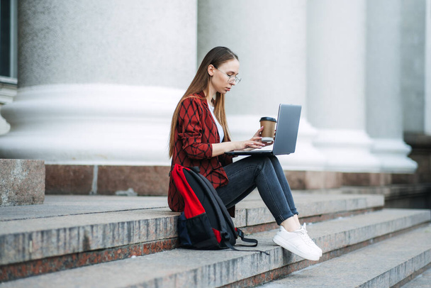 Make money online, blogging, ebusiness. Young woman, freelancer, student girl using laptop for distance job or making money online. Creative woman working on laptop outdoors - Foto, immagini