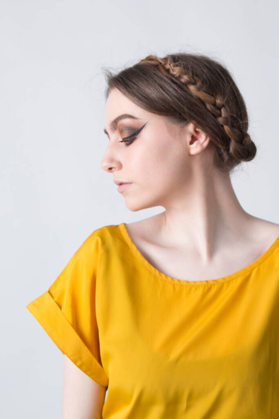 beautiful elegant female wearing a yellow top on a white background - Photo, image