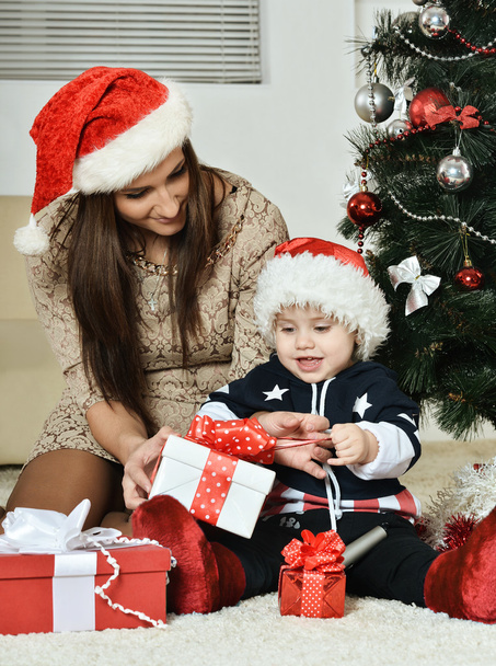 Mother with boy near Christmas tree - Foto, Imagen