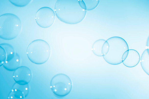 Abstract Beautiful Transparent Blue Soap Bubbles Background. Soap Sud Bubbles Water. - Photo, Image