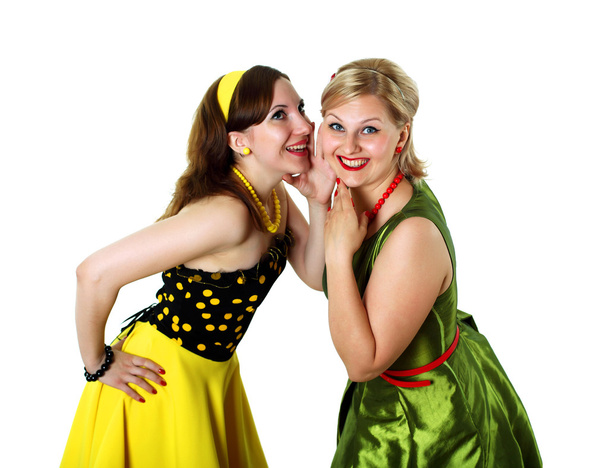 Two young woman in bright colour dresses - 写真・画像