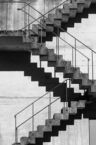 Abstract architecture background, square concrete stairway perspective, stairwell, black and white photo. Minimalism architecture. Modern architecture with distinguishing shades of black and white. - Foto, imagen
