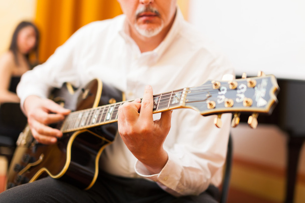 Guitarist playing an archtop guitar - 写真・画像