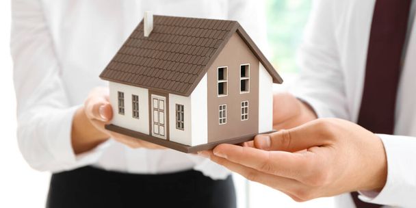 Couple with model of house, closeup. Concept of buying property - Photo, image