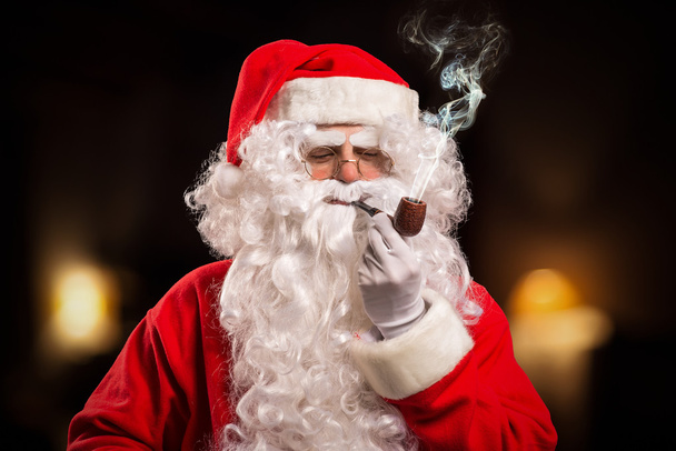 Santa Claus smoking a pipe - Fotoğraf, Görsel