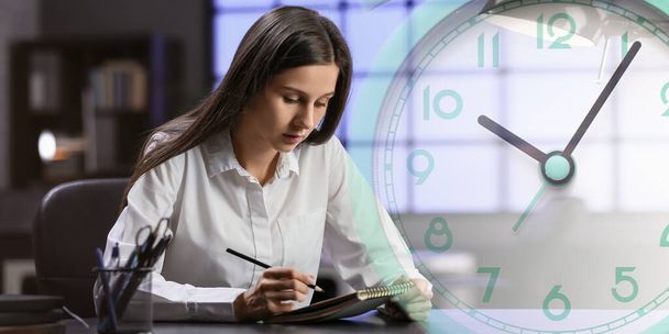 Double exposure of clock and young businesswoman working in office late in evening. Deadline concept - 写真・画像
