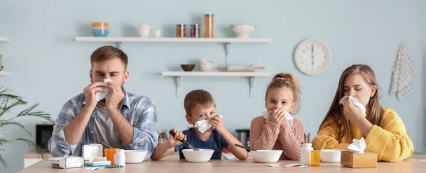 Family ill with flu eating chicken soup in kitchen - Valokuva, kuva
