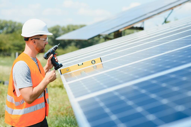 Worker installing solar panels outdoors. - Zdjęcie, obraz