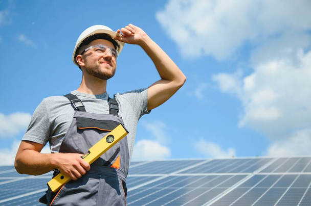 A man working at solar power station - Photo, Image