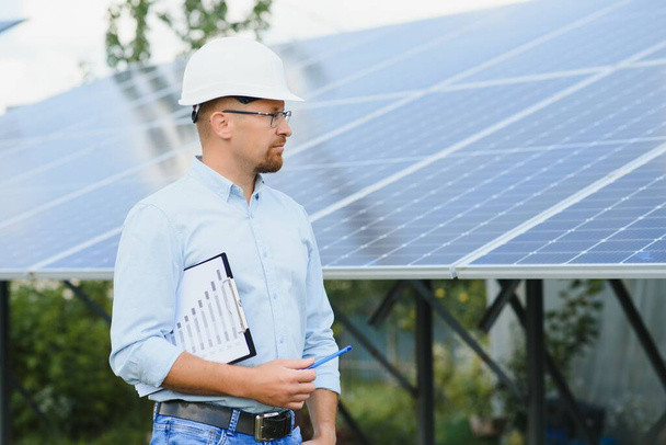 Worker installing solar panels outdoors. - Fotoğraf, Görsel