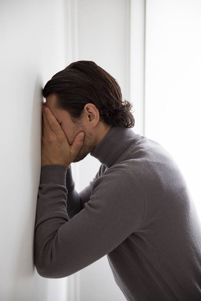 Depressed man on studio background - Фото, зображення