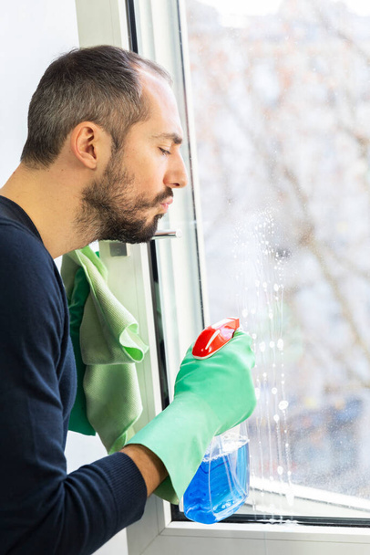 A man cleaning a window. - 写真・画像