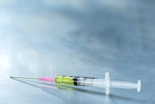 Syringe closeup isolated on grey slate. - Fotografie, Obrázek
