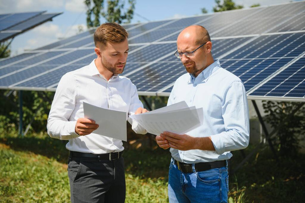 engineer and businessman planing new ecology project. around solar panel. - Foto, Imagem