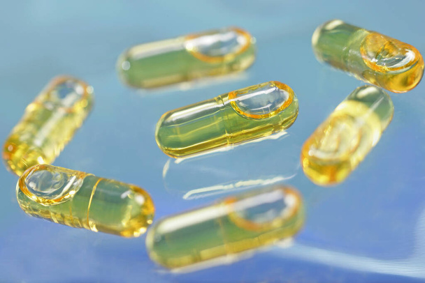 Capsules of cod liver oil. Cod liver oil is consummed mainly for its richness in vitamin A and D, but it also contains omega 3. - Fotó, kép