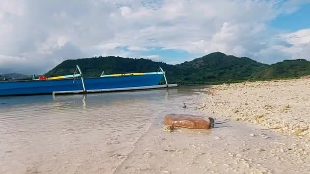 Τα καθαρά νερά της θάλασσας είναι κατάλευκα και κυματιστά στην άκρη της πανέμορφης λευκής αμμώδους παραλίας. Η τοποθεσία είναι στο Boalemo Regency, στην επαρχία Gorontalo. εξωτερική φωτογραφία στις 11 Αυγούστου 2022 - Πλάνα, βίντεο