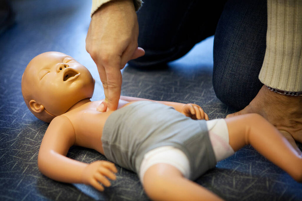 First aid training: cardiac massage on an infant. - Foto, Bild