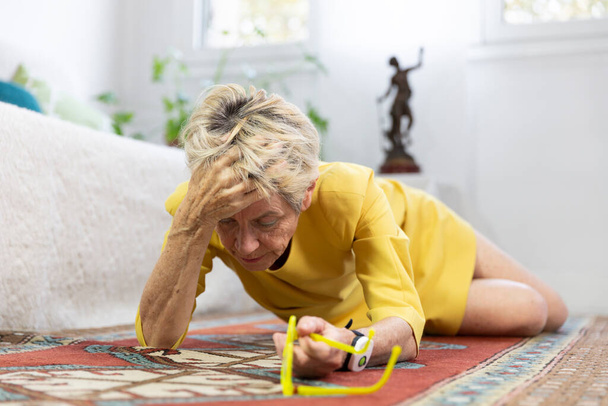 An elderly woman on her floor having fallen. - Zdjęcie, obraz