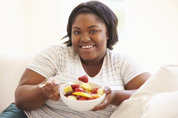 Overweight Woman  Eating  Fruit - Fotoğraf, Görsel