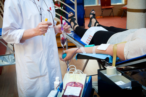A team of nurses take care of the blood collection. - Photo, image