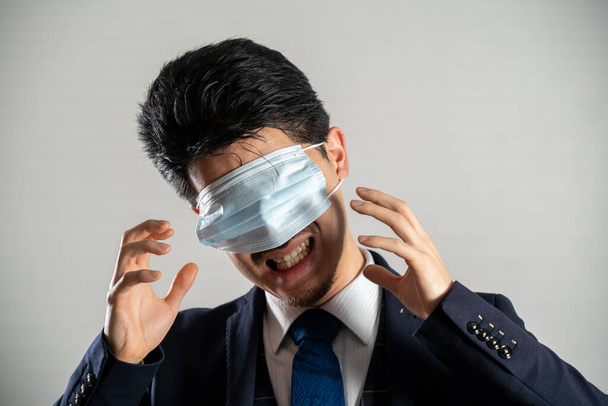 Screaming man wearing a mask over his eyes - Foto, Imagen