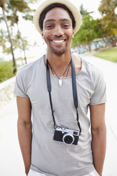 Young Man Carrying Camera - 写真・画像