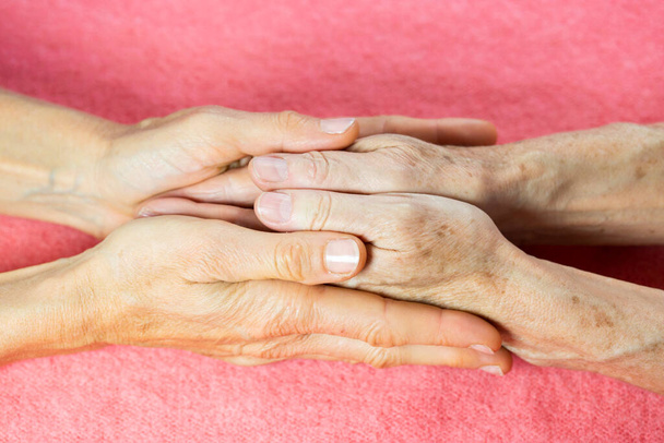An elderly woman and young womans hands.  - Foto, Imagen