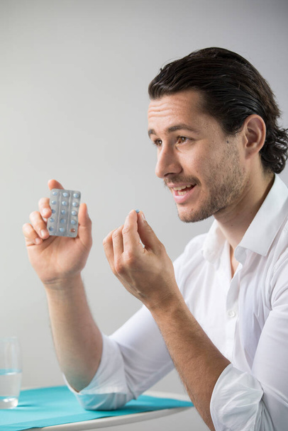 Man taking contraceptive pill. - Valokuva, kuva