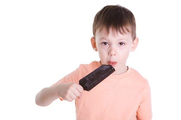Kaunis poika syö kylmää jäätelöä. Eristetty valkoisella pohjalla
 - Valokuva, kuva