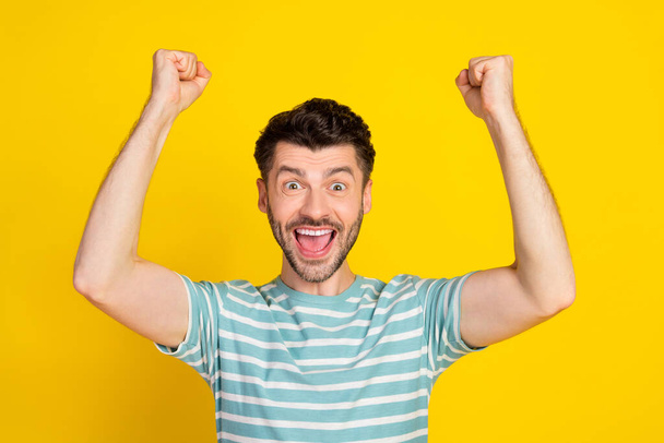 Closeup photo of young funny celebrating guy fan victory hooray win football club isolated on yellow color background. - Valokuva, kuva