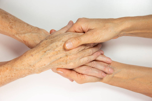 An elderly woman and young womans hands.  - Photo, image