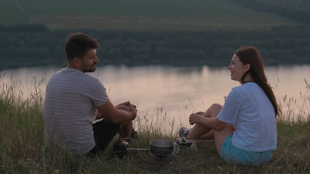 The romantic couple sitting on mountain top and drinking tea - Photo, Image
