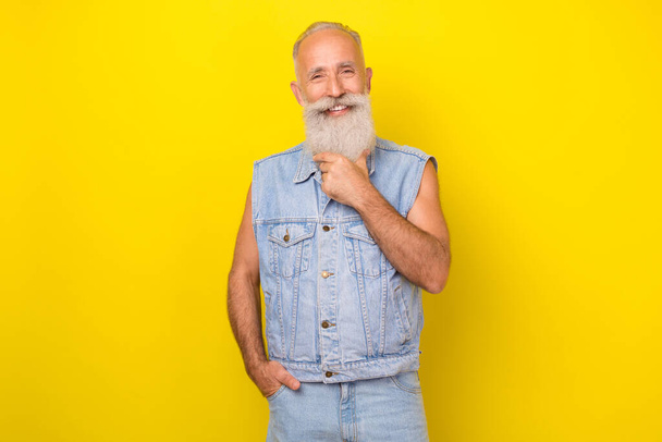 Photo of cool charming retired guy wear jeans waistcoat smiling hand arm chin isolated yellow color background. - Fotografie, Obrázek